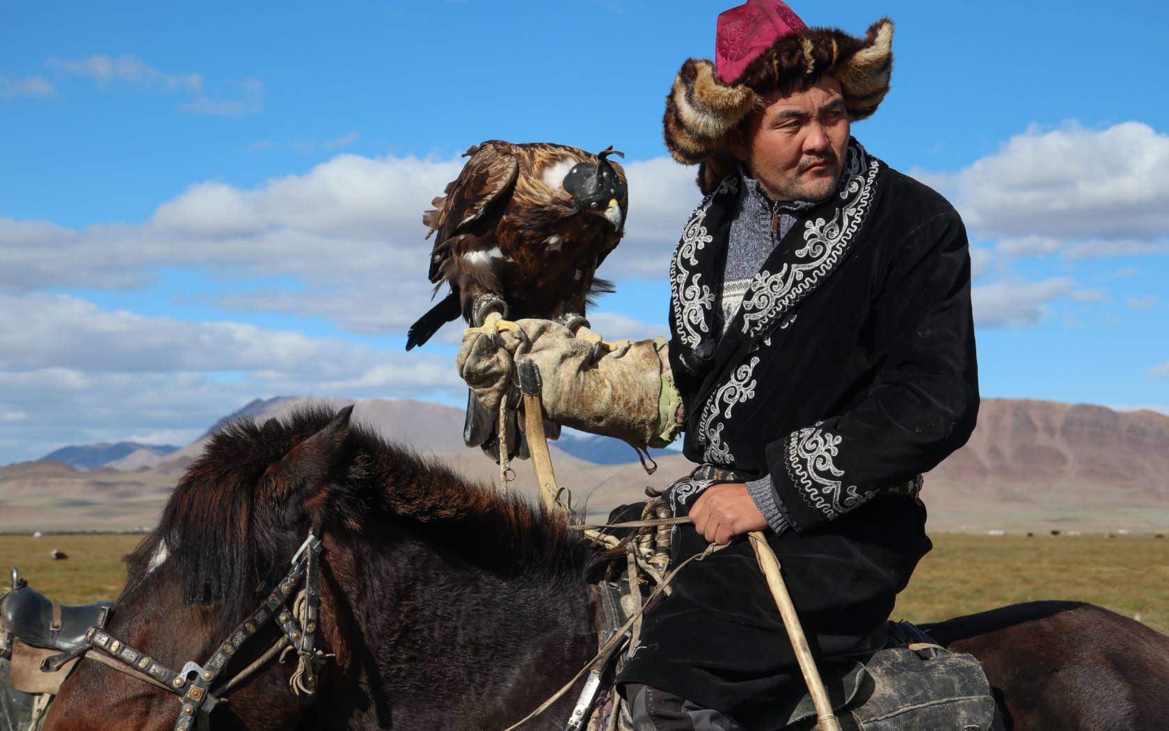 A Kazakh eagle hunter on horseback.